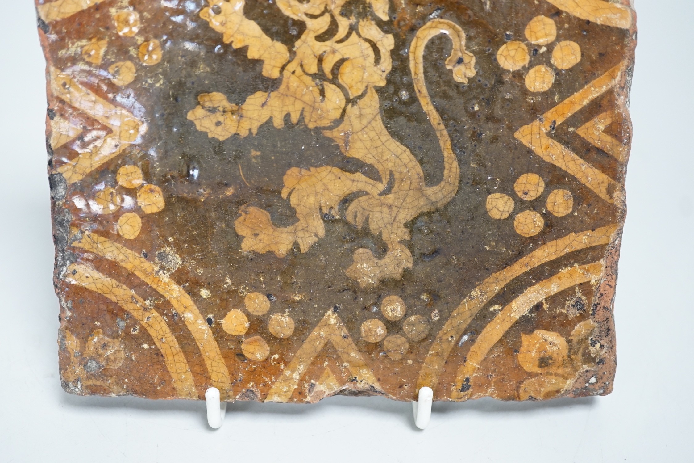 A single early ecclesiastical floor tile with rampant lion detail. 14 x 14cm